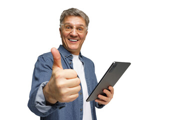 Older man smiling and giving thumbs up while holding a tablet in a bright setting