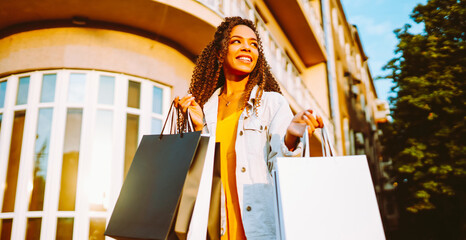 Young woman with shopping bags. Consumerism, sale, purchases, shopping, lifestyle concept