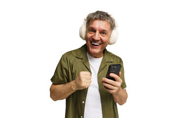 Excited man wearing headphones enjoys music while looking at his smartphone with joy
