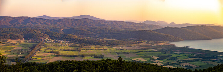 Fototapeta premium Cityscape from Sakartepe viewpoint at sunset with Aegean sea and mountains not far from Marmaris. Mugla, Turkey