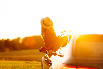 Beauty woman enjoy in road trip in car at sunset. Full of joy. Lifestyle, travel, tourism, nature, active life