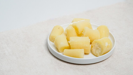 boiled cassava in a white plate and white background