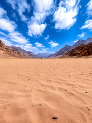 Naklejka premium Vast desert landscape with mountain range under a partly cloudy sky, scenic views