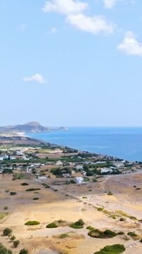 Vertical drone shot rising in front of the east coast of Rhodes, sunny Greece