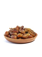 Pile of sweet dates on a wooden plate isolated on white background. Dried date fruit or dates, ramadan food