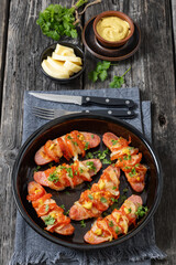 hot sausages baked with cheese, tomato, mustard