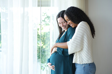 Interracial lesbian couple enjoying pregnancy