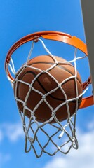 On a bright and sunny day, the basketball makes a satisfying swish as it passes cleanly through the net at the outdoor court