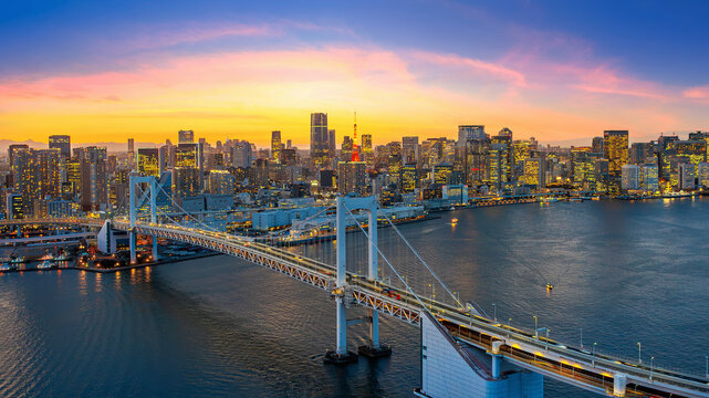 Rainbow bridge and Tokyo cityscape at sunset, Japan.