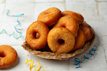 Italian Carnival pastry. Homemade fried yeast raised italian graffe, with a dough made of flour and potatoes. Doughnuts or donuts sugar-coated. Typical food of Neapolitan cuisine.