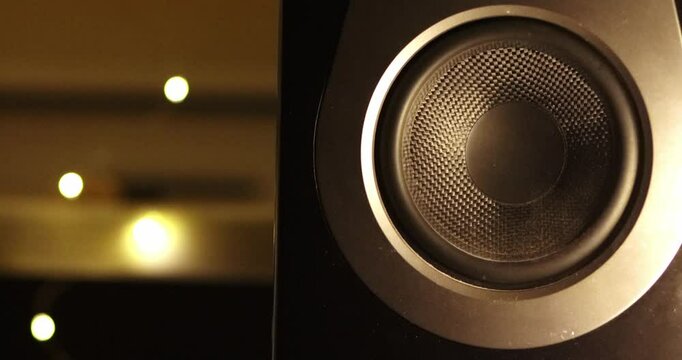 Blasting music on studio speakers. Close up of studio speaker bass subwoofer moving while listening song for music production, and jamming out studio monitors. Sound engineer playing loud music 
