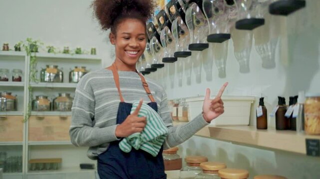 Young female shopkeeper work checking and openings at refill store, zero waste, plastic-free grocery merchandise, and an eco-friendly retail business startup.	
