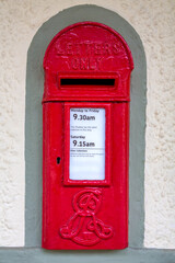 Edwardian postbox set into a wall. Traditional red British letter box from the era of Edward VII...