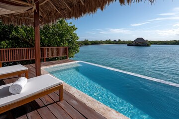 A serene poolside view overlooking a tranquil body of water, surrounded by lush greenery and a thatched-roof structure, perfect for relaxation.