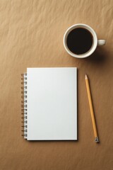 Blank notepad, pencil, and coffee cup on brown background.