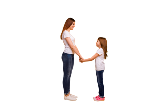 Full length profile side photo of lovely mommy with her kid having long haircut holding hands isolated over yellow background
