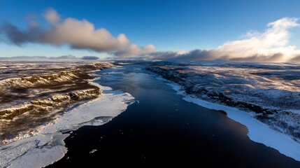 Obraz premium Aerial View of a Frozen River in a Winter Landscape