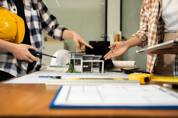 brainstorming and measuring for cost estimating on paperworks and floor plan drawings about design architectural and engineering for houses and buildings..