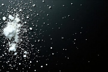 White paint droplets on a black background wall, expressive,