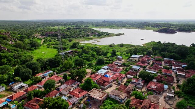 indian people living in Nountiled houses with lake and greenery at yelupugonda village, Tekmal, telangana. day time, semi circle, drone shot, 4k.