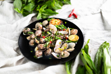 Tasty clams and mussels served with garlic, herbs, and lime, creating a delightful seafood dish.