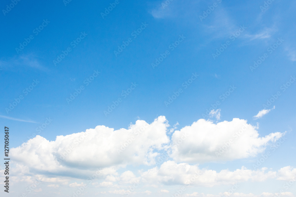 Wall mural sky with fluffy clouds. dynamic scene in day light. white cumulus cloudscape on a blue gradient of a