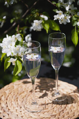 Refreshing drinks served in elegant glasses amidst blooming flowers