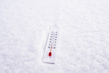 Thermometer on winter snow background. Thermometer for measuring outdoor air temperature. Cold...