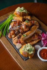 Deep fried battered snacks for beer on a wooden tray on the table