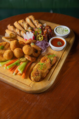 Deep fried battered snacks for beer on a wooden tray on the table