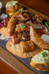 Deep fried battered snacks for beer on a wooden tray on the table