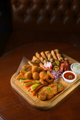 Deep fried battered snacks for beer on a wooden tray on the table