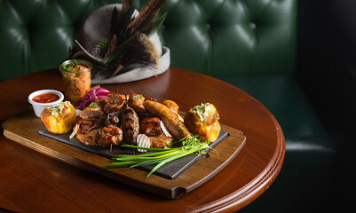 Deep fried battered snacks for beer on a wooden tray on the table