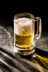 glass of beer on black background