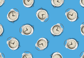 Pattern of white alarm clocks on pale blue background
