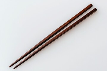 Two chopsticks side by side on a white background, ready for use in Asian cuisine