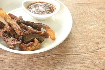 fried crispy salty fermenting beef meat on plate dipping spicy and sour sauce