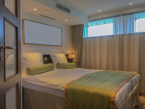 View into river view outside exterior cabin stateroom with queen king double bed onboard luxury river cruiseship cruise ship liner with panoramic porthole window