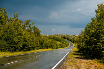 An empty road in the mountains at sunset