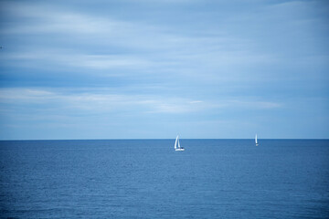 Obraz premium Yacht in the sea. Sailing boat on the sea. Sailboat on the sea. Horizon. Sea and blue sky