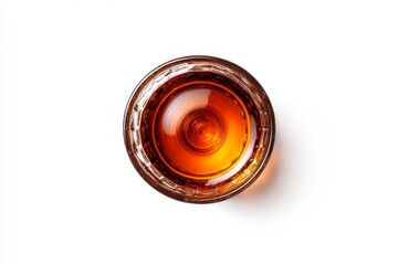 Glass of amber liquid on solid white surface. AI generated