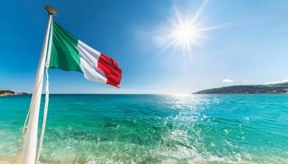 Fototapeta premium Italian flag flying above a Mediterranean beach.