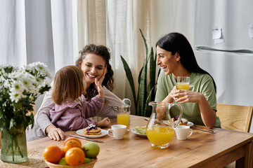 Loving lgbtq family enjoys a cheerful breakfast in their cozy modern apartment