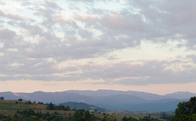 Soft Sunset Glow: Evening Sky Above the Mountains