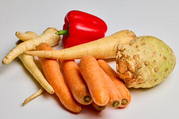 mixed root vegetables on a wooden chopping board