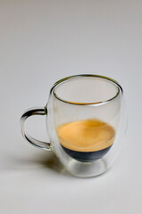 a double-walled glass mug with coffee on a table