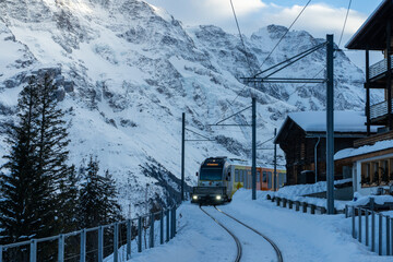 Train in Murren and Mountains in Winter Evening. Swiss Alps. Switzerland