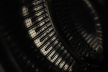Close-Up of Modern Washing Machine Drum with Intricate Metal Texture and Holes