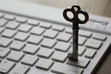 Antique Key on Computer Keyboard Symbolizing Cybersecurity and Data Access