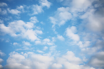 Serene Blue Sky with White Fluffy Clouds on a Bright Sunny Day